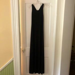 Floor length black gown.